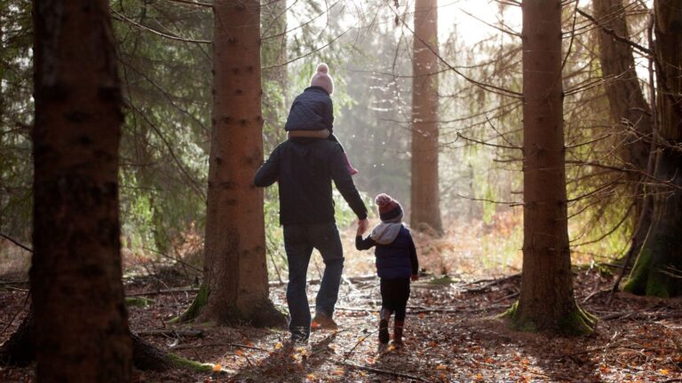 Family walking through peaceful countryside on a quiet day out near London